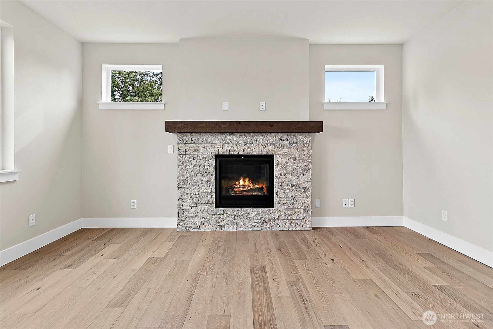 19129 Meridian Drive Southeast, Unit CW19 Bothell, WA 98012 - Photo 14 of 29 a view of an empty room with wooden floor and a fireplace