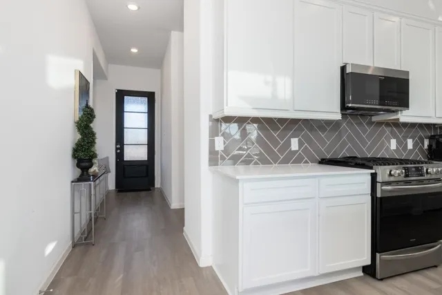 a kitchen with a stove and a microwave