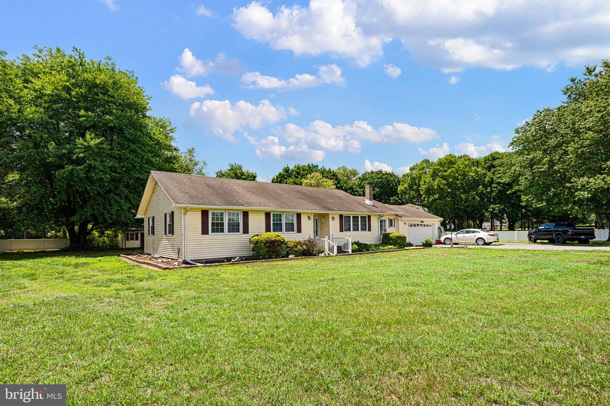 3302 Barratts Chapel Road Frederica, DE 19946 - Photo 3 of 19 a view of a house with a big yard and large trees