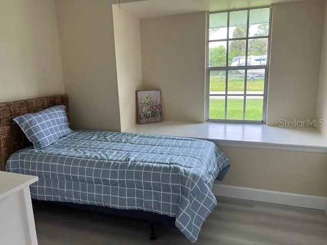 a bedroom with a bed and a window