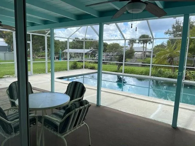 a view of a patio with a table chairs and backyard