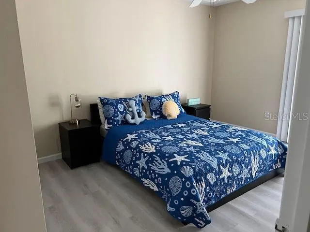 a bed sitting in a bedroom next to a window