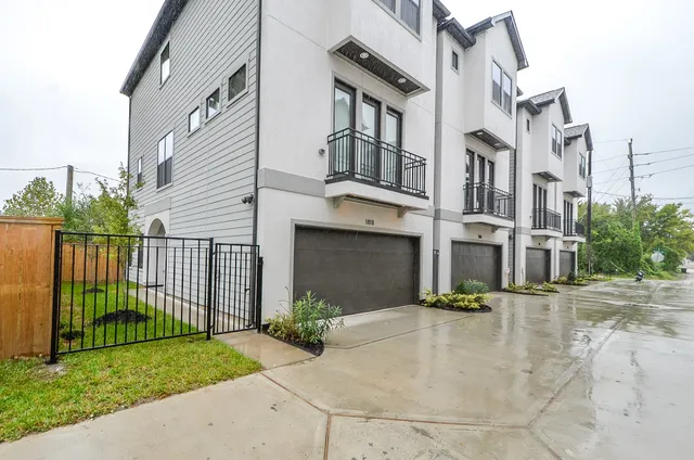 a view of a brick building next to a yard