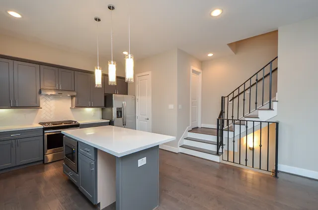 a kitchen with a stove a sink and a refrigerator