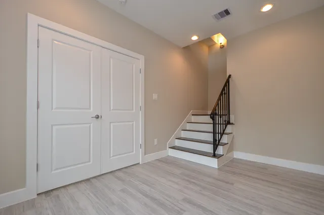 wooden floor in an empty room with stairs