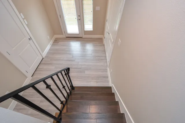 a view of entryway with wooden floor and stairs