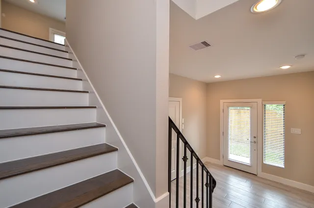 a view of entryway with wooden floor and stairs