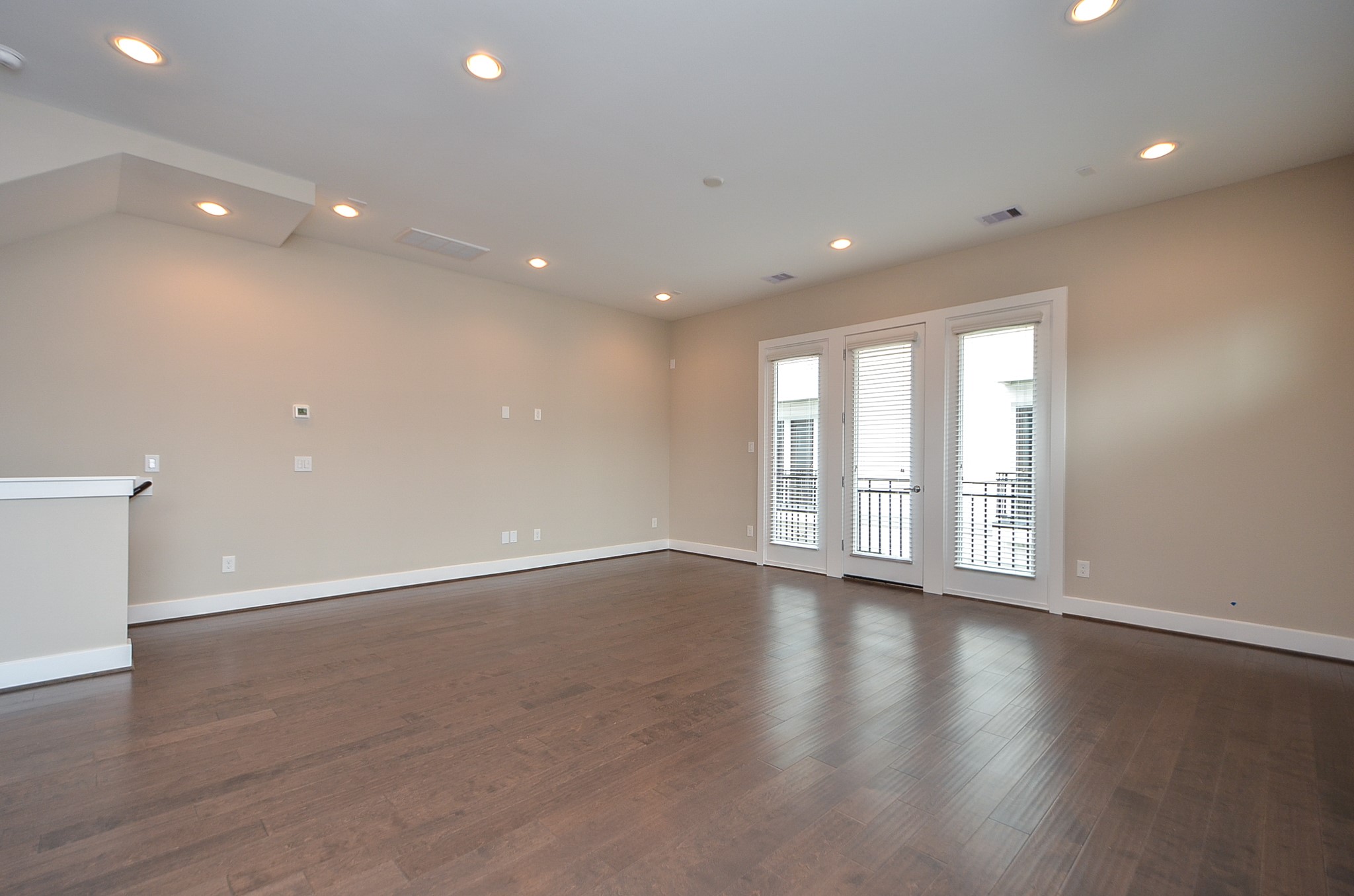 1818 Bonner Street Houston, TX 77007 - Photo 9 of 26 a view of an empty room with wooden floor and a window