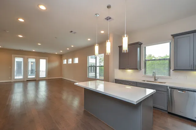 a large kitchen with granite countertop a sink and a large window