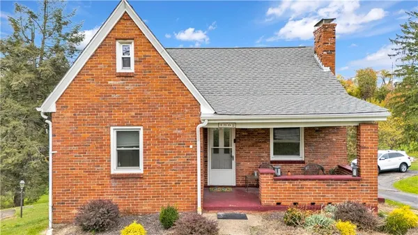 a view of a house with wooden fence