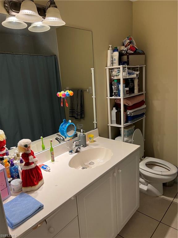 4618 19th Court Southwest Naples, FL 34116 - Photo 11 of 16 a bathroom with a sink vanity mirror and toilet