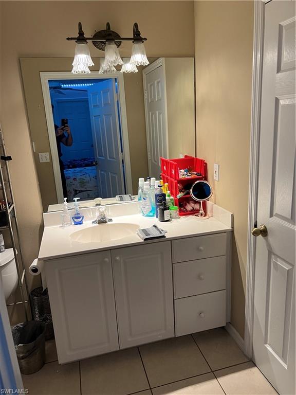 4618 19th Court Southwest Naples, FL 34116 - Photo 12 of 16 a bathroom with a sink and a mirror