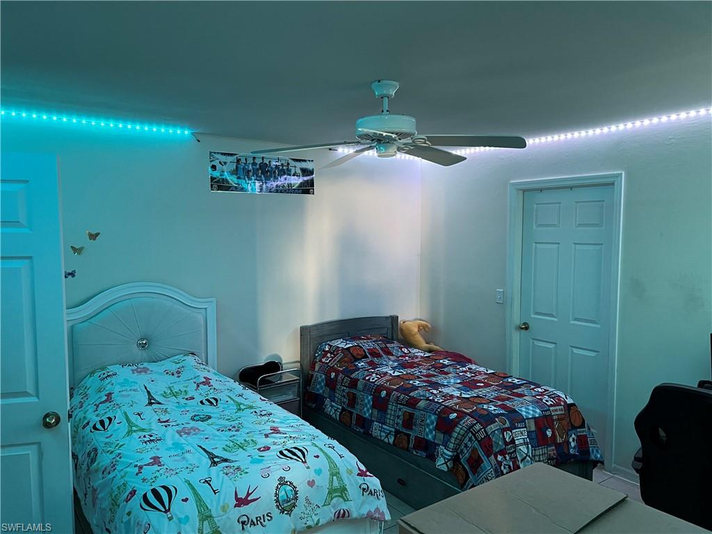 4618 19th Court Southwest Naples, FL 34116 - Photo 14 of 16 a bedroom with a bed and a chandelier