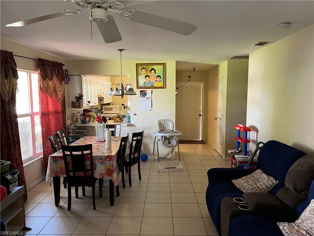 4618 19th Court Southwest Naples, FL 34116 - Photo 15 of 16 a living room with furniture and a flat screen tv