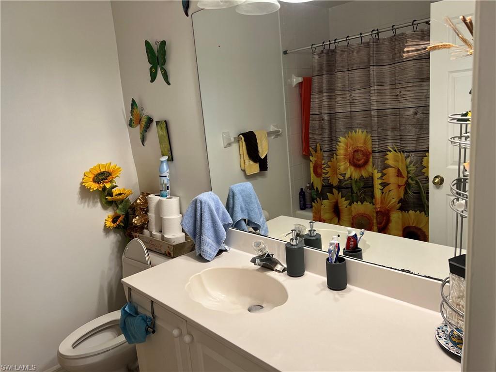 4618 19th Court Southwest Naples, FL 34116 - Photo 4 of 16 a bathroom with a sink and a mirror