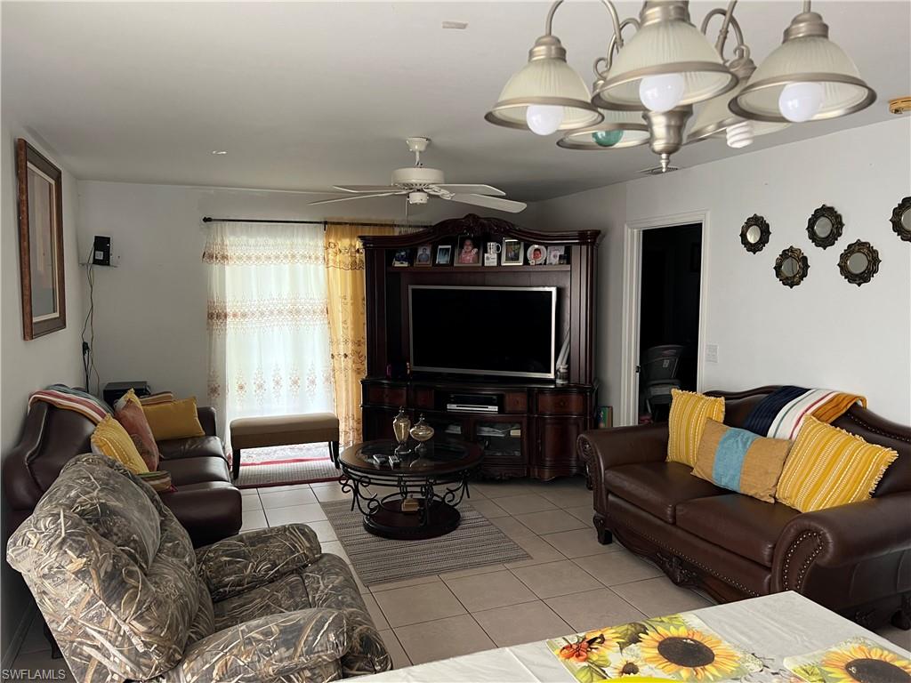 4618 19th Court Southwest Naples, FL 34116 - Photo 8 of 16 a living room with furniture and a flat screen tv