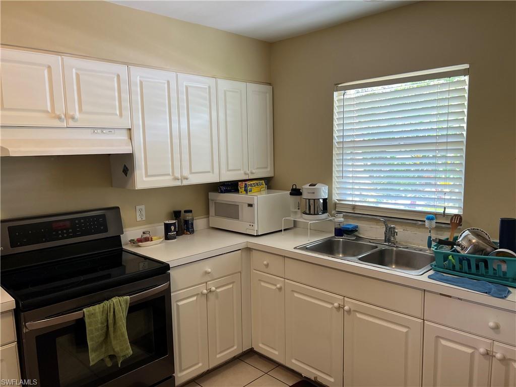 4618 19th Court Southwest Naples, FL 34116 - Photo 9 of 16 a kitchen with sink cabinets and appliances