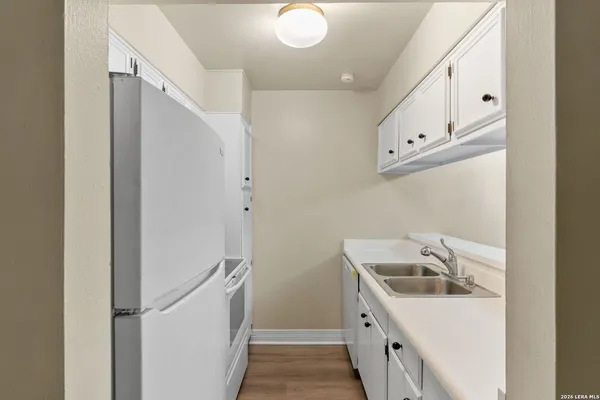 a bathroom with a sink and mirror with shower