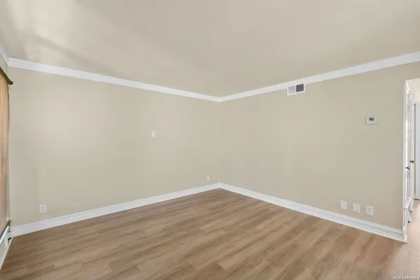 a view of a room with wooden floor