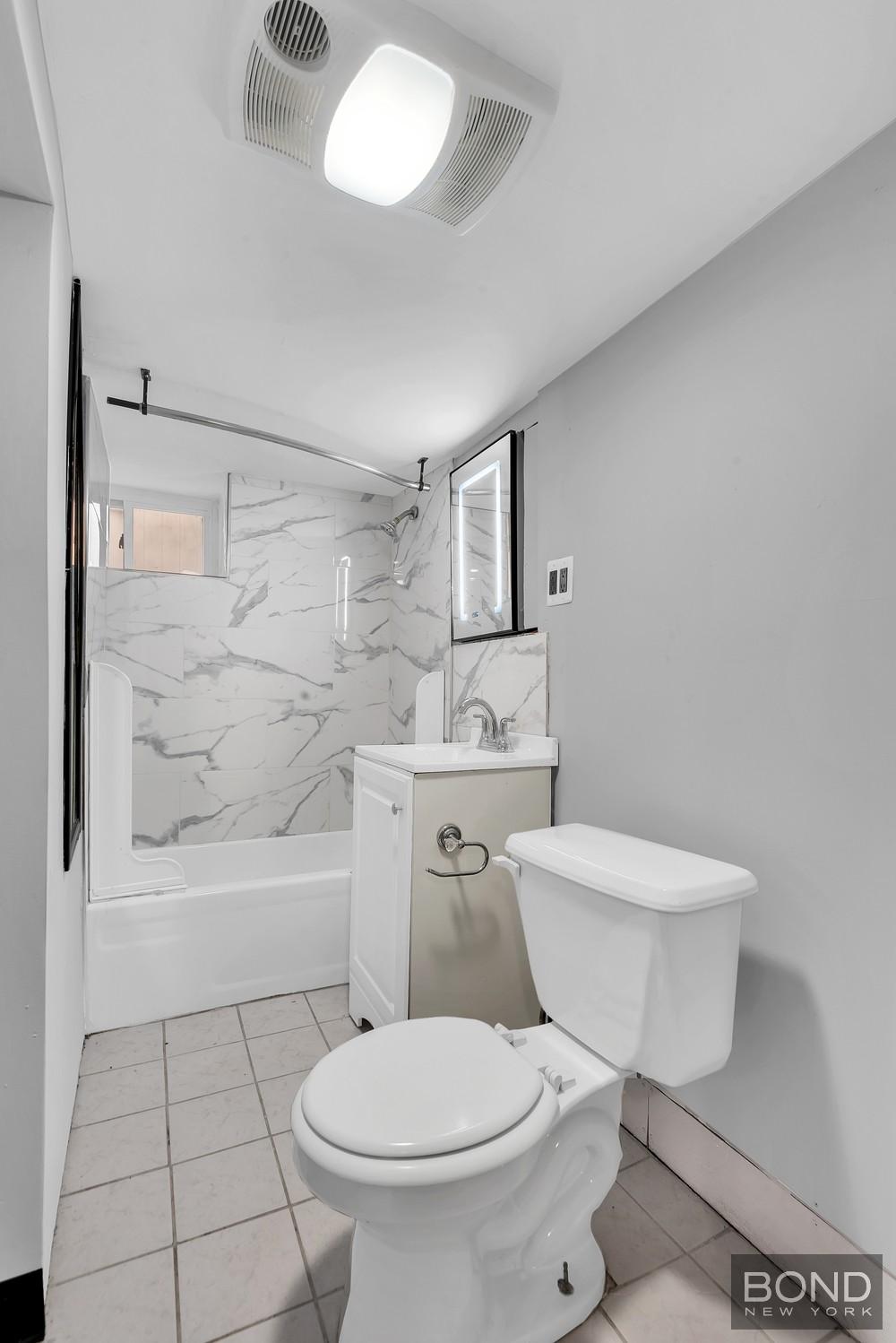 119-73 Merrill Street Queens, NY 11434 - Photo 10 of 12 a white toilet sitting next to a bathroom sink