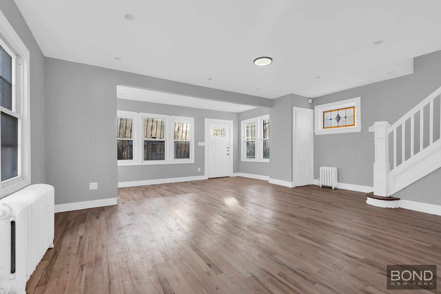 119-73 Merrill Street Queens, NY 11434 - Photo 2 of 12 a view of empty room with wooden floor and fan