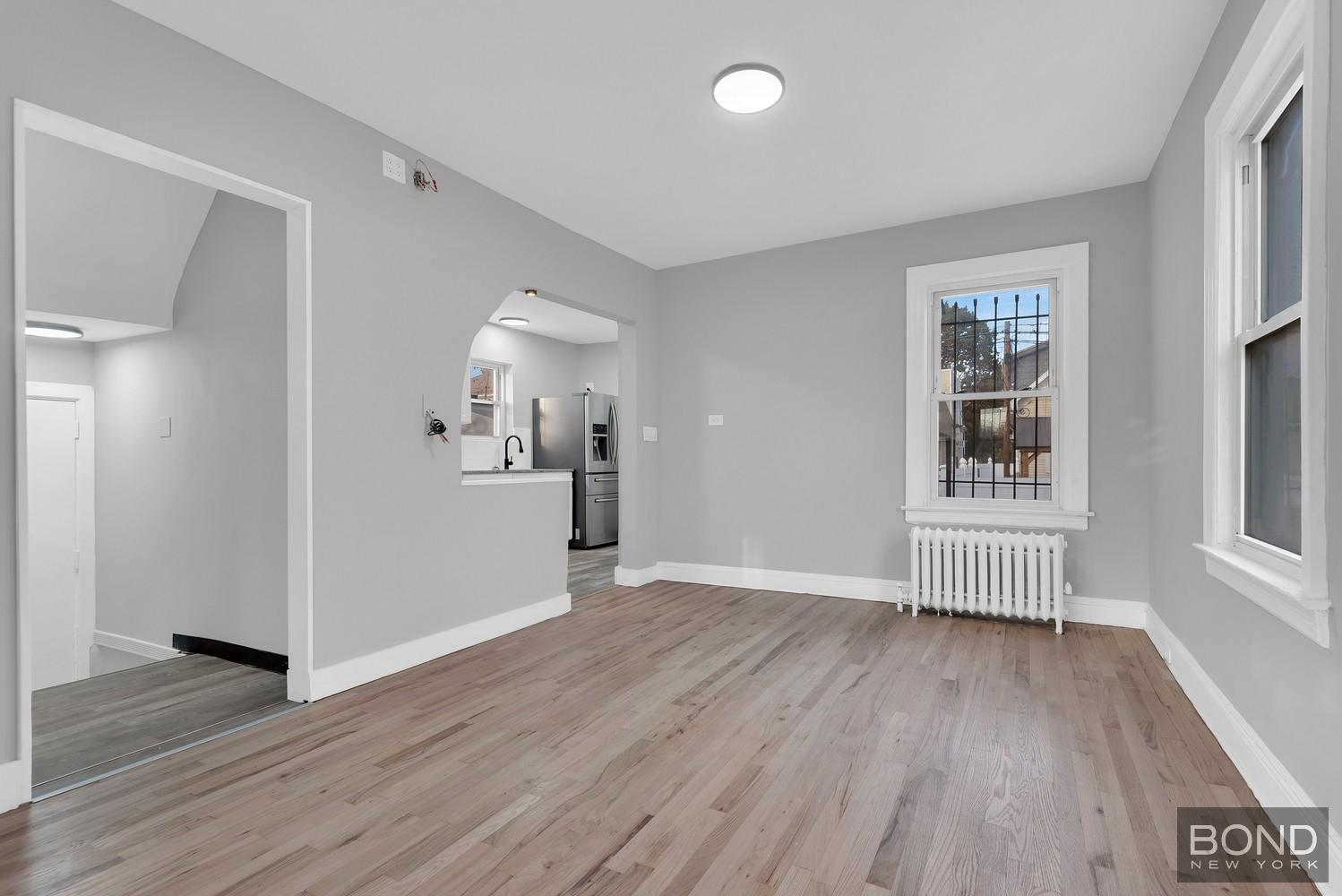 119-73 Merrill Street Queens, NY 11434 - Photo 3 of 12 wooden floor in an empty room with a window