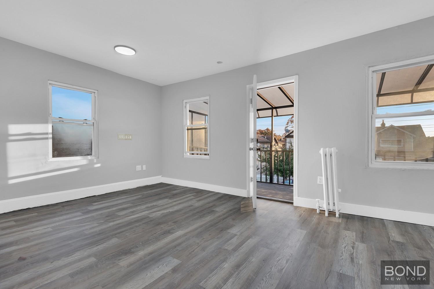 119-73 Merrill Street Queens, NY 11434 - Photo 6 of 12 a view of an empty room with wooden floor and a window