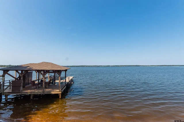 a view of a lake with a lounge chair