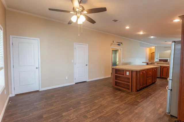 a view of kitchen with granite countertop cabinets and wooden floor
