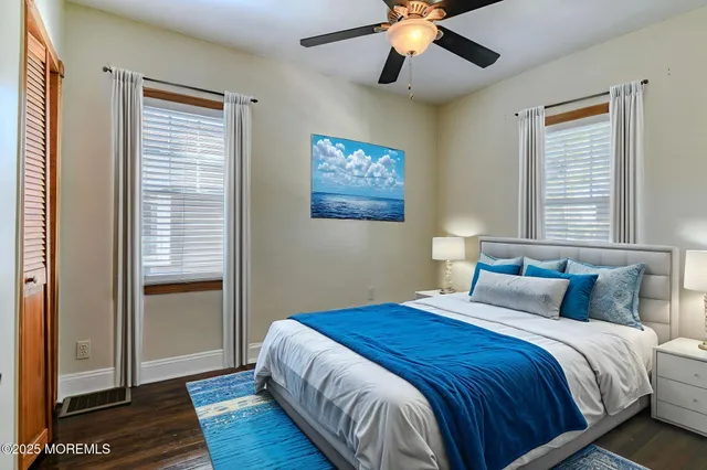a bedroom with a large bed chandelier and a window