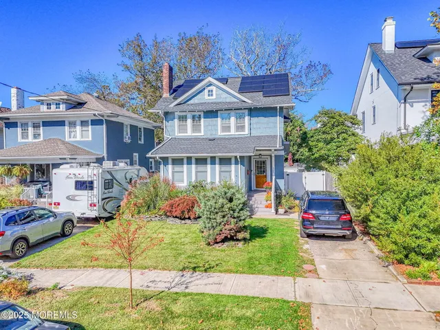 a front view of a residential apartment building with a yard