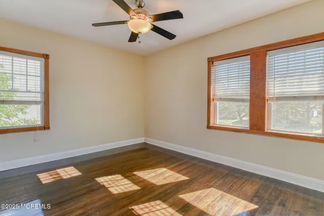 a view of a room with wooden floor and natural light