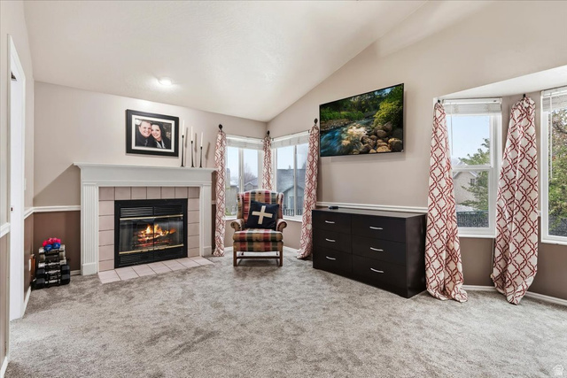 7975 Showcase Lane Sandy, UT 84094 - Photo 15 of 29 Primary bedroom with fireplace and vaulted ceiling