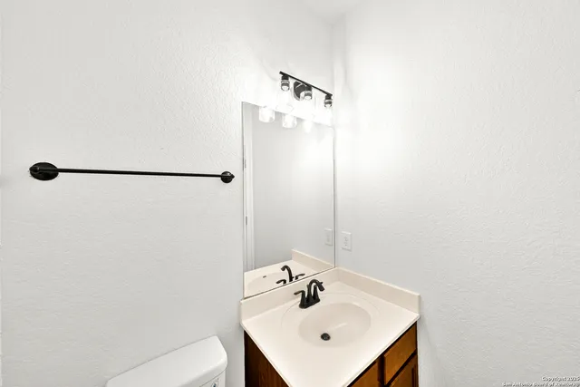 a bathroom with a sink a mirror and shower