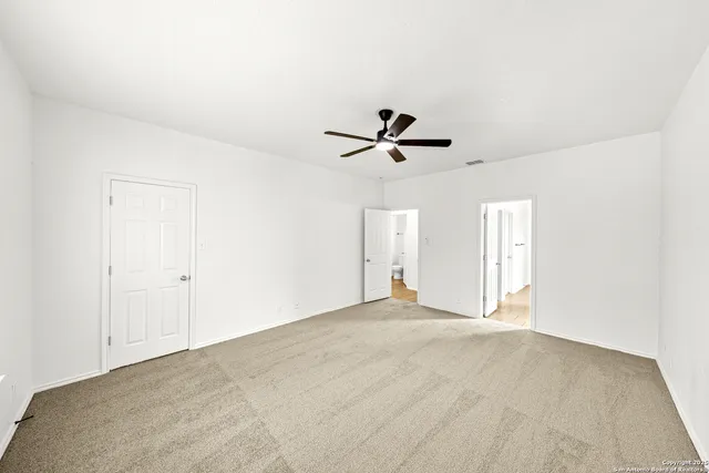 a view of a livingroom with a ceiling fan and window