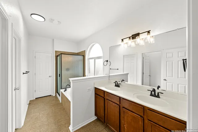 a bathroom with a double vanity sink mirror and