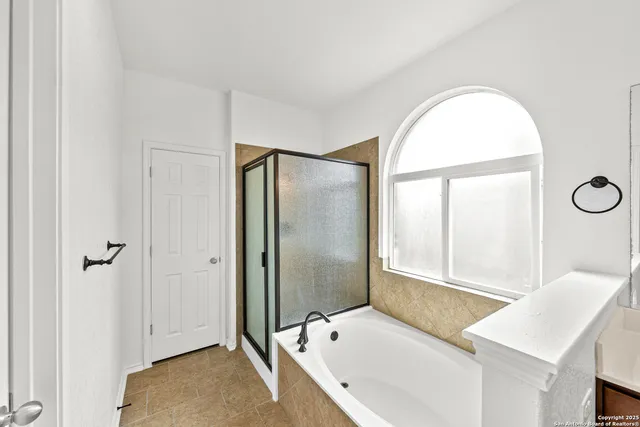 a bathroom with a tub and a sink