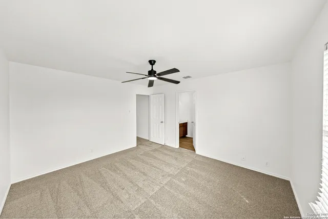 a view of a room with a ceiling fan