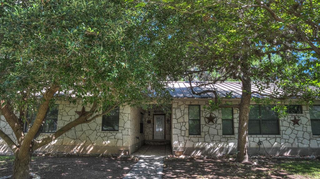 187 Roy Chisum Road Leakey, TX 78873 - Photo 4 of 40 a front view of a house with a yard