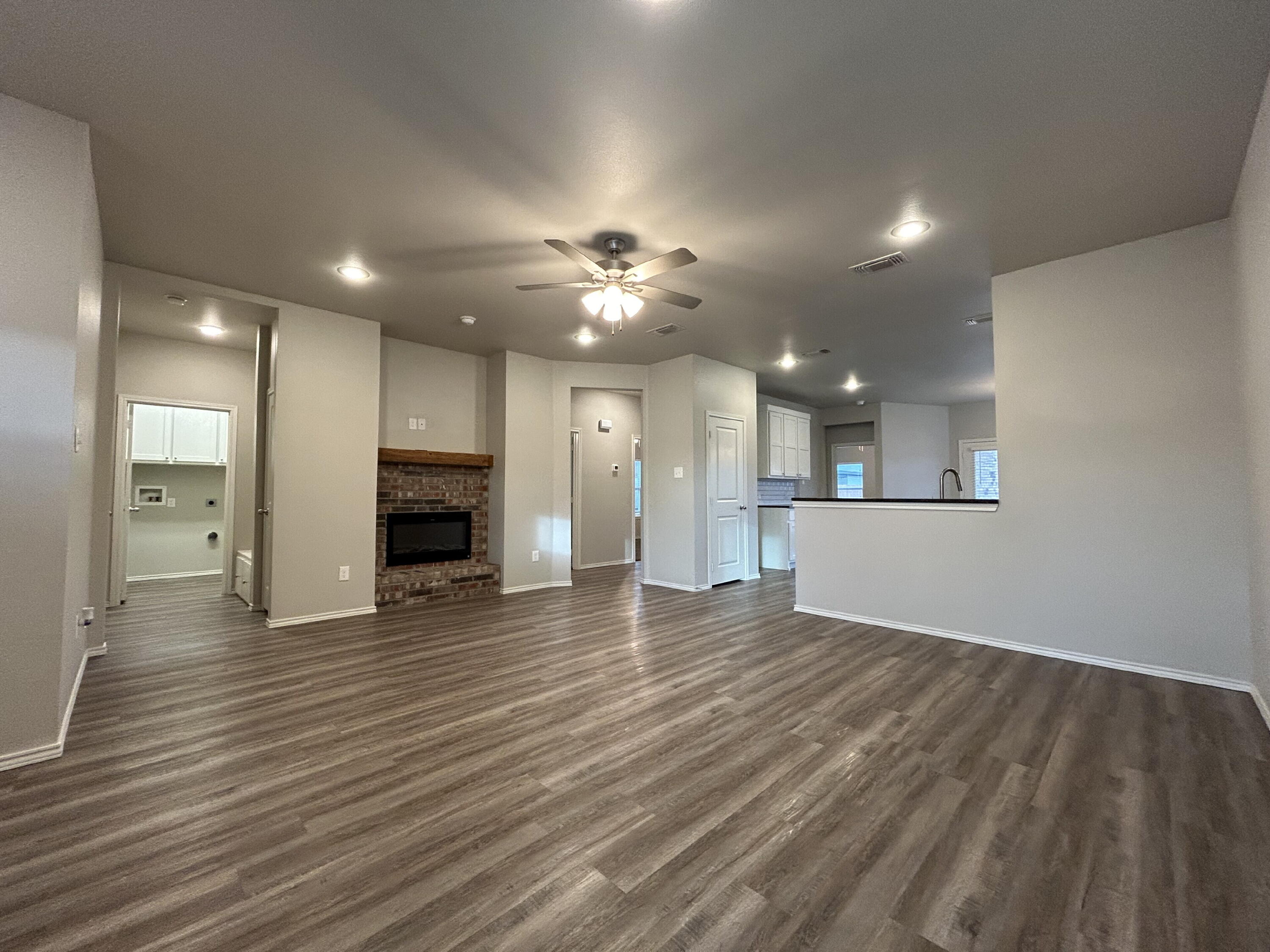 5843 Itasca Street Lubbock, TX 79416 - Photo 2 of 10 a view of a kitchen with a sink and a refrigerator