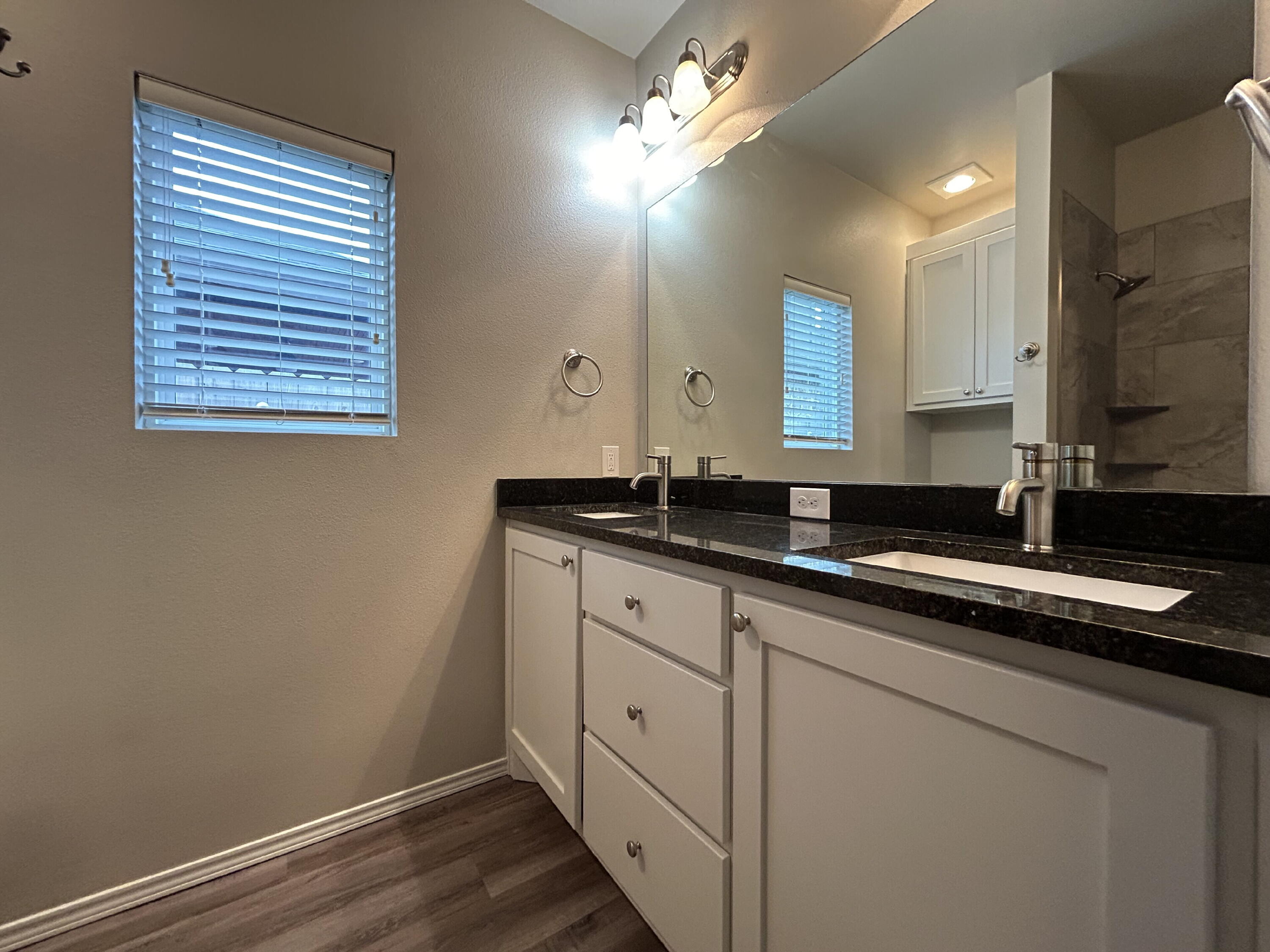 5843 Itasca Street Lubbock, TX 79416 - Photo 6 of 10 a bathroom with a sink and a mirror