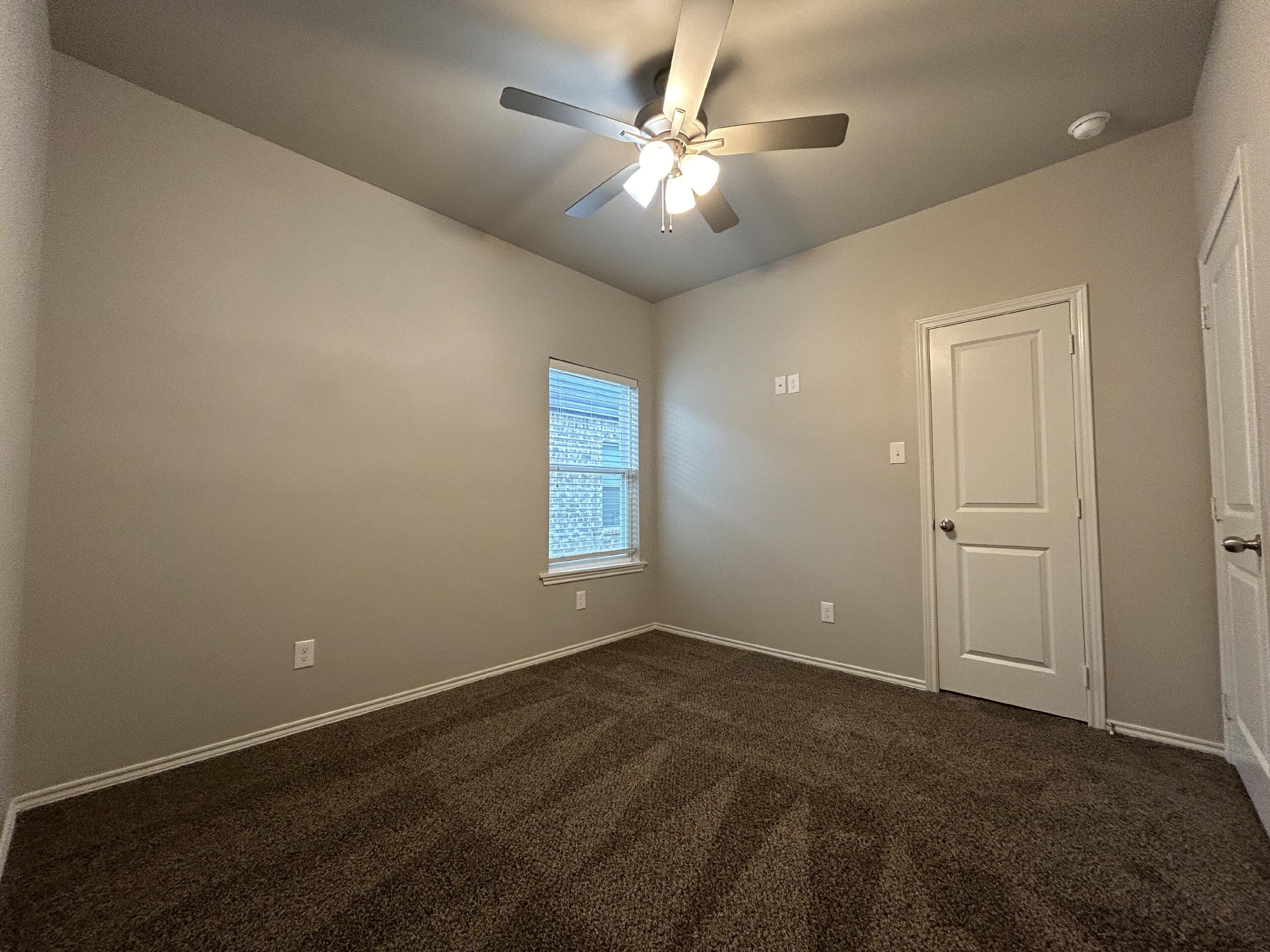 5843 Itasca Street Lubbock, TX 79416 - Photo 8 of 10 an empty room with fan and windows