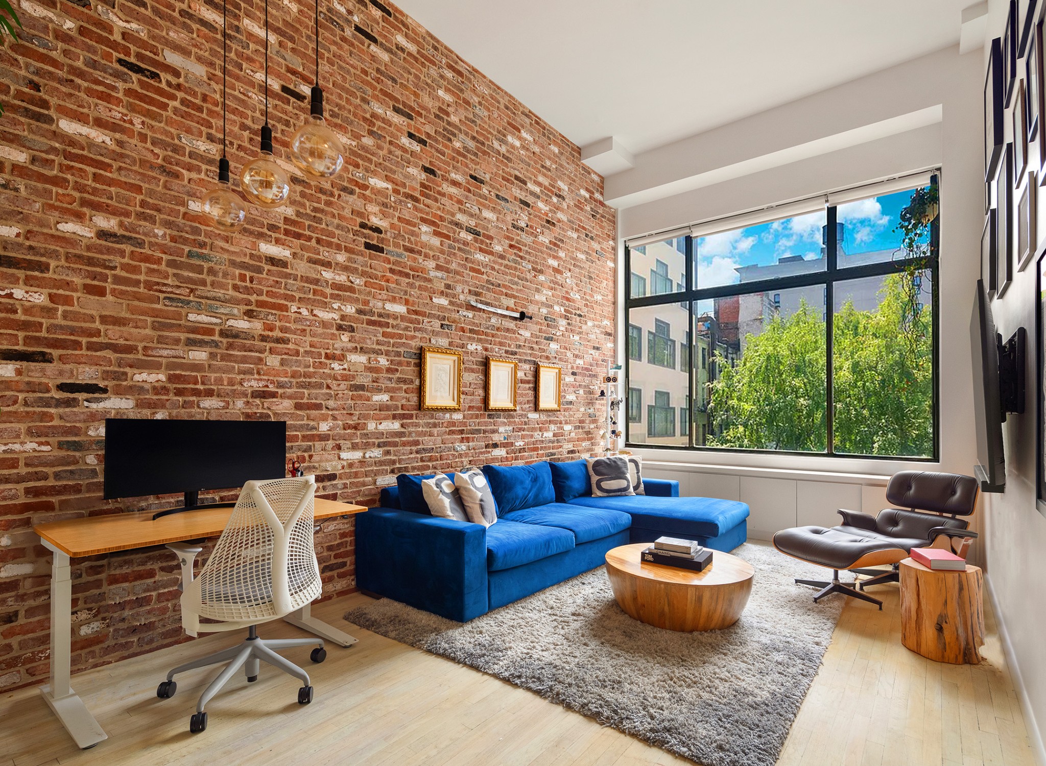 a living room with furniture a flat screen tv and a fireplace