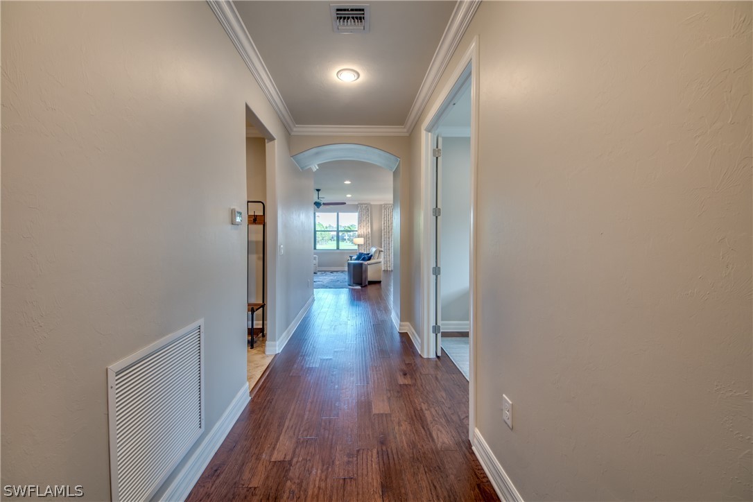 10898 Dennington Road Fort Myers, FL 33913 - Photo 2 of 35 a view of a hallway with wooden floor