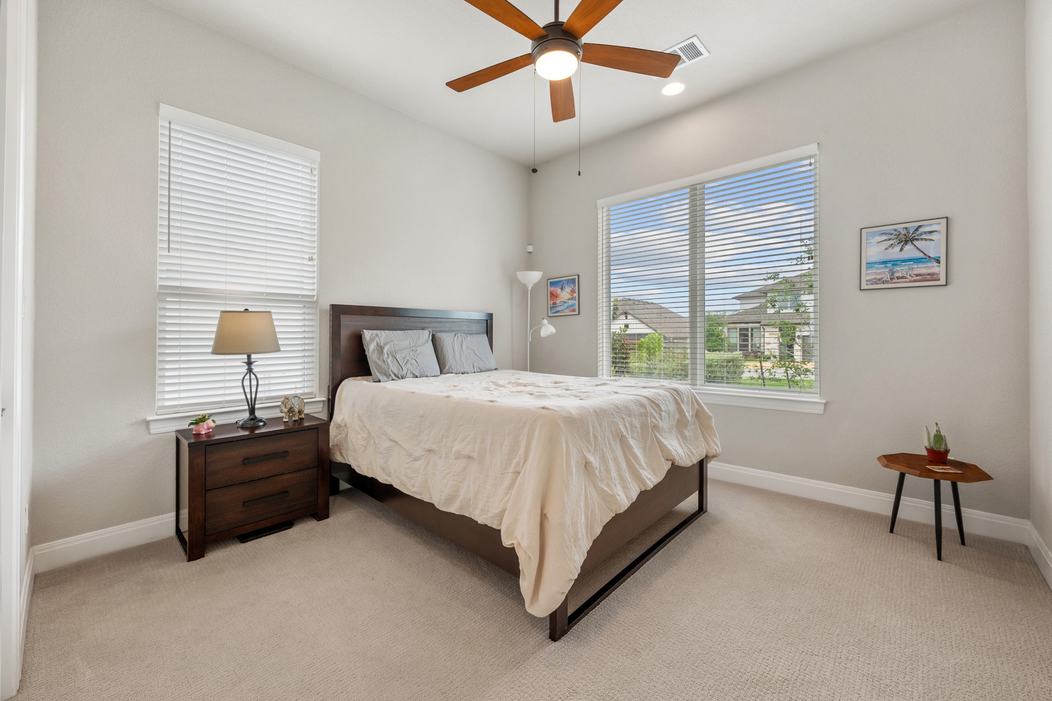 510 Elworth Path Austin, TX 78738 - Photo 15 of 40 a bedroom with a bed and a chandelier