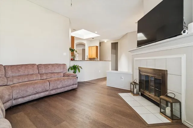 a living room with furniture a flat screen tv and a fireplace