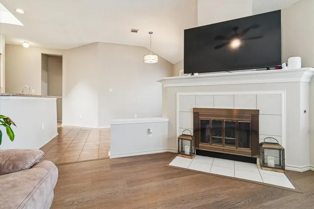 a living room with a fireplace and a flat screen tv