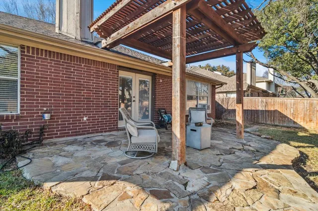 a view of a patio with table and chairs potted plants