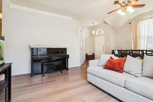 a living room with furniture and a piano