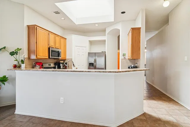 a view of kitchen with microwave and cabinets